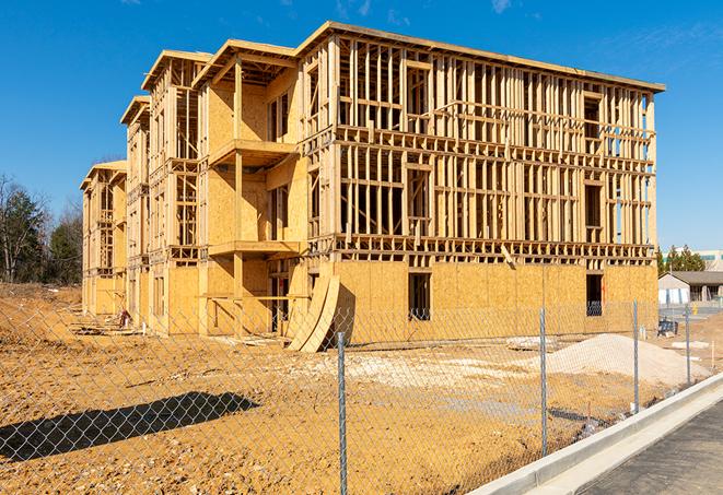 a close-up of temporary chain link fences enclosing a construction site, signaling progress in the project's development in Essex, MA